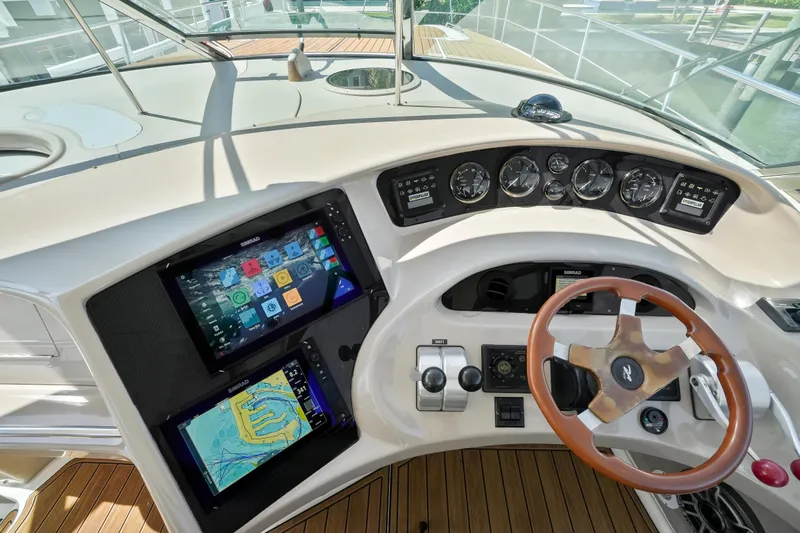 Yacht Photos Pics Helm of 2001 Sea Ray 510 Sundancer with modern navigation displays and wooden steering wheel.