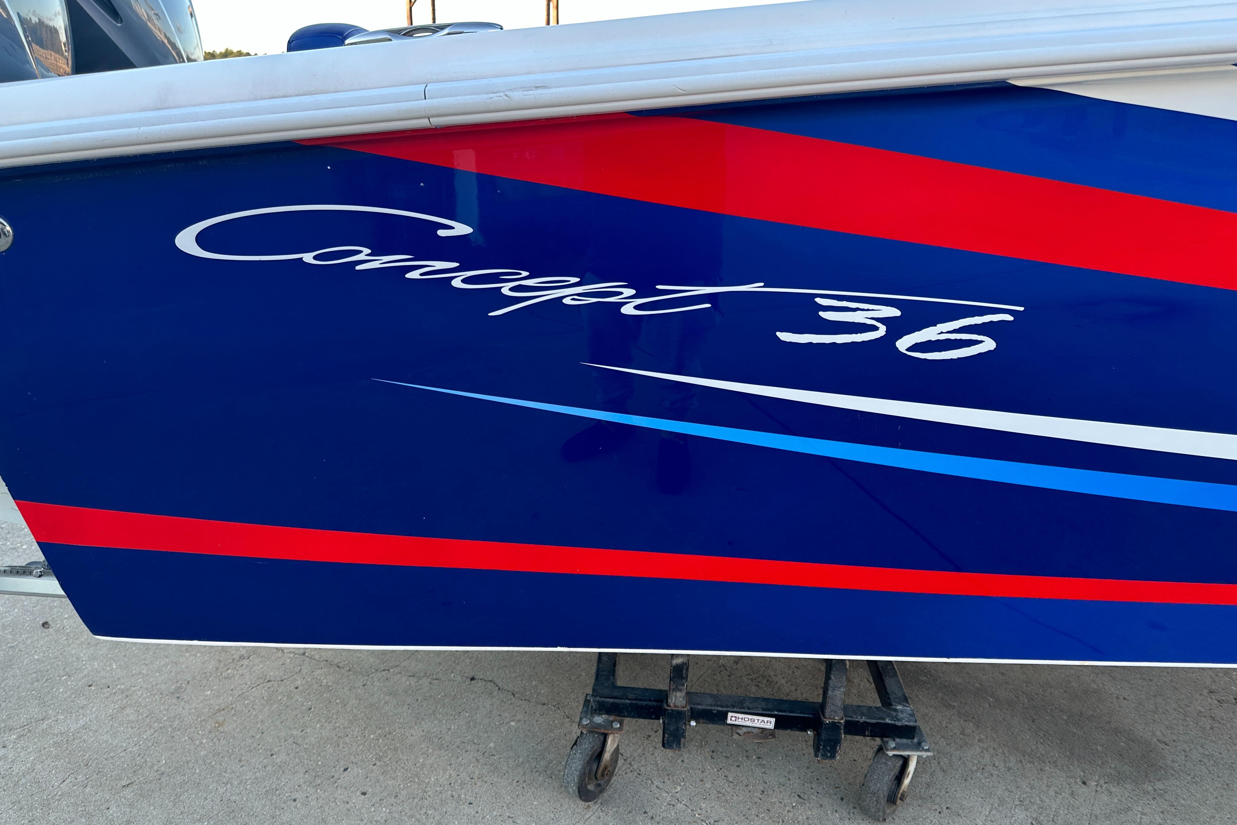 Blue and red Concept 36 boat, 2014 model, on a stand.