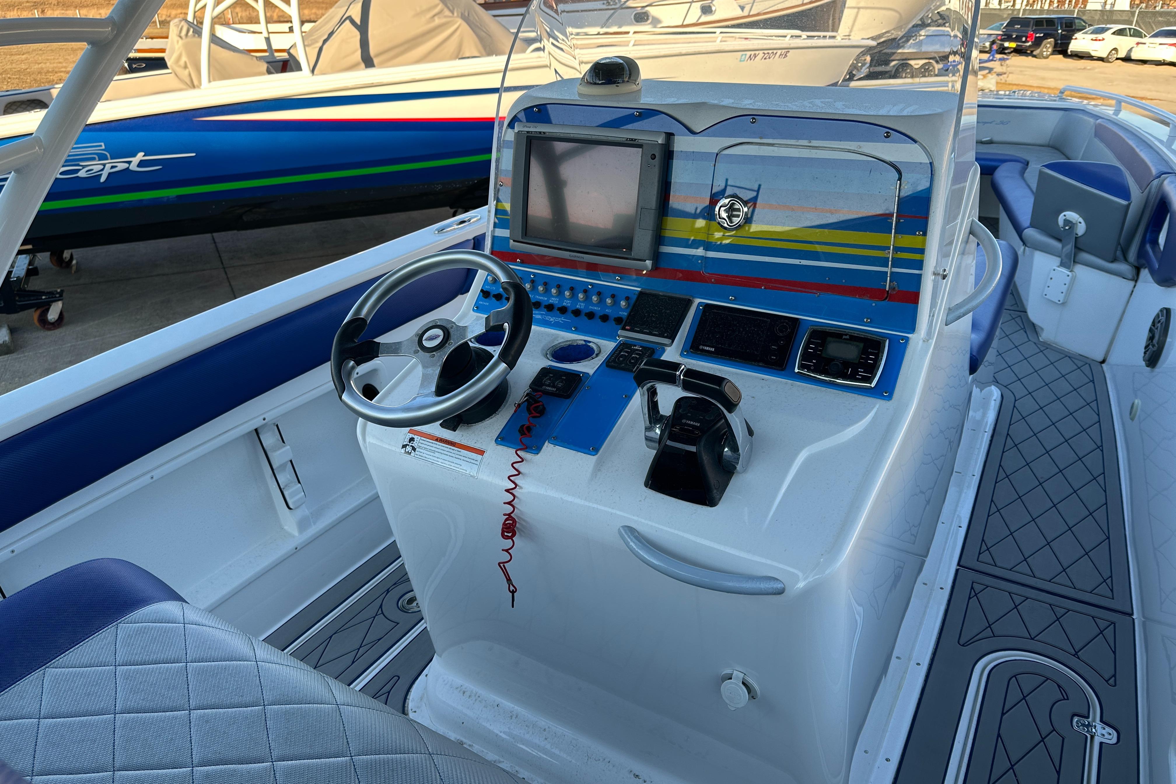 Concept 36 boat cockpit, 2014 model, featuring steering wheel and navigation controls.
