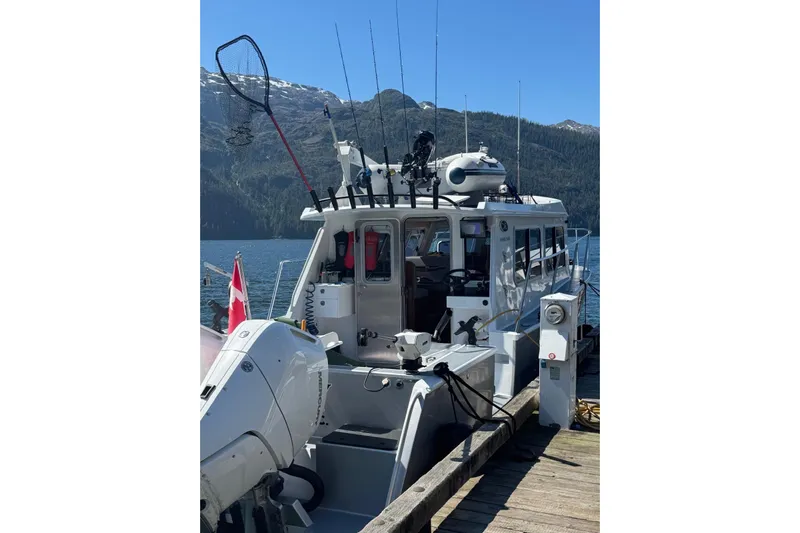 Hardy Yacht Photos Pics 2020 Coastal Craft 33 ProFish boat docked with fishing gear and scenic mountain backdrop.