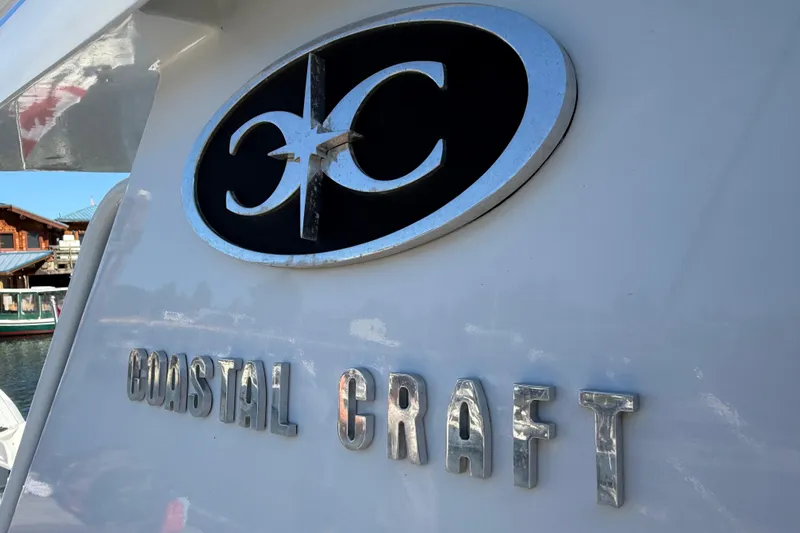 Hardy Yacht Photos Pics 2020 Coastal Craft 33 ProFish boat logo and nameplate in marina setting.