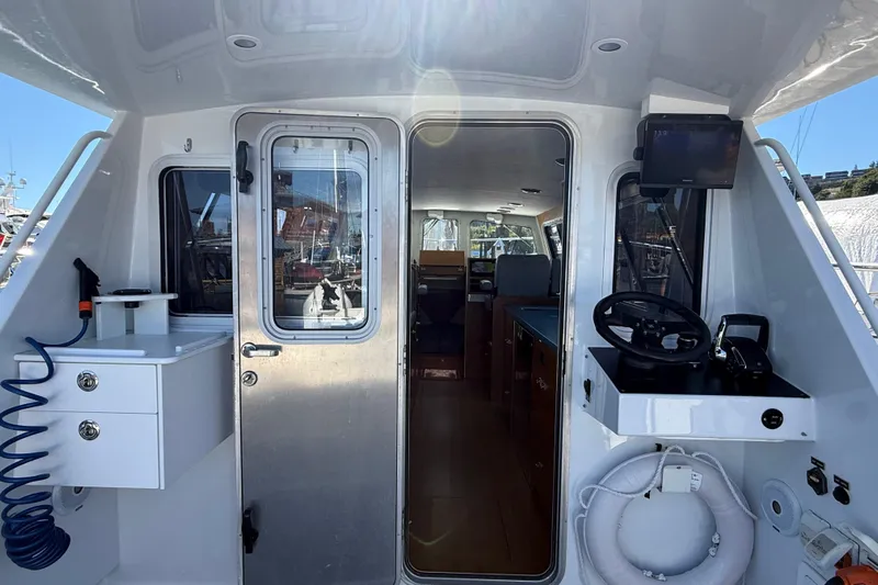 Hardy Yacht Photos Pics 2020 Coastal Craft 33 ProFish boat interior with helm, seating, and equipment.