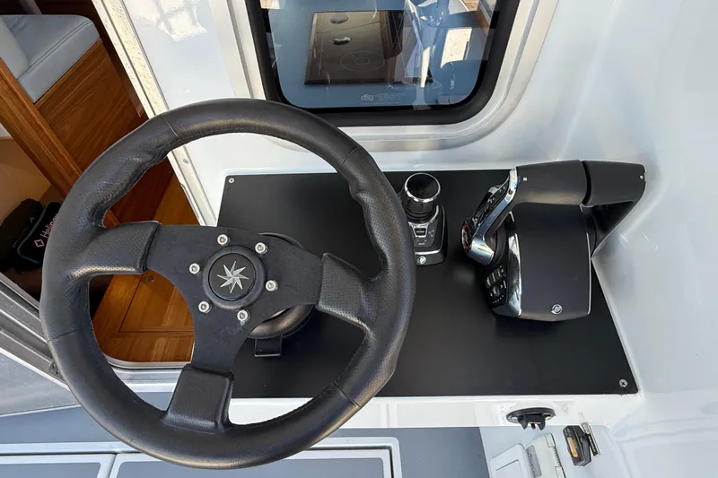 Hardy Yacht Photos Pics Steering wheel and controls of 2020 Coastal Craft 33 ProFish boat cockpit.