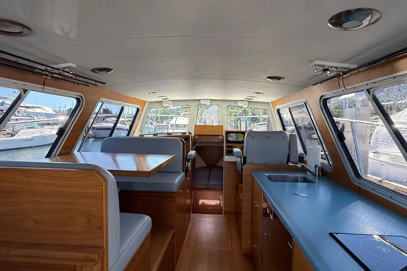 Hardy Yacht Photos Pics Interior of 2020 Coastal Craft 33 ProFish boat with seating and kitchenette.