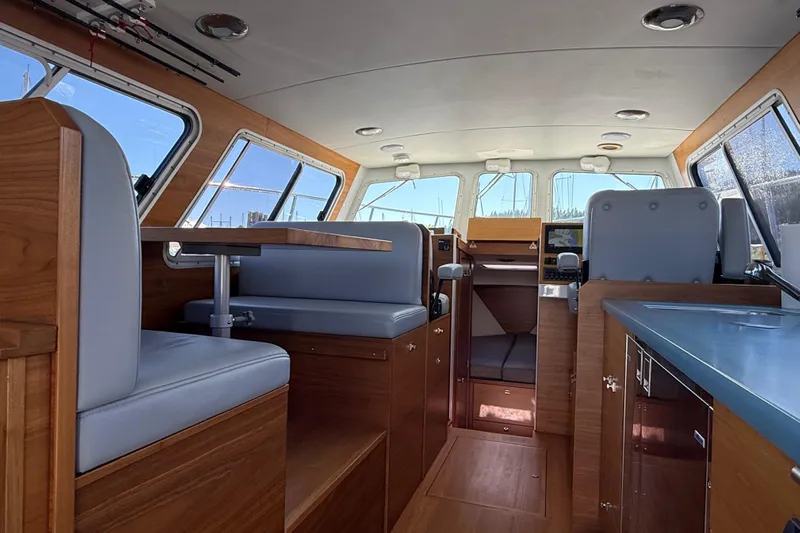 Hardy Yacht Photos Pics Interior of 2020 Coastal Craft 33 ProFish boat with wood finish and seating area.