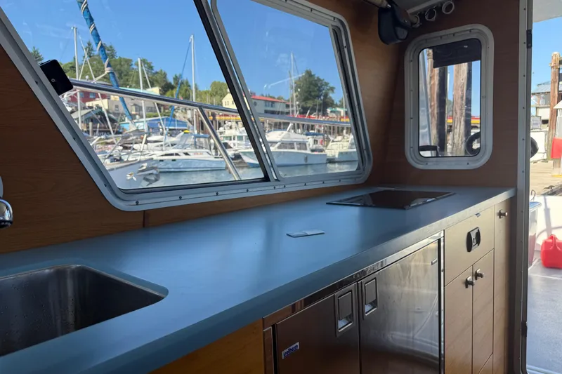 Hardy Yacht Photos Pics Interior of 2020 Coastal Craft 33 ProFish boat with modern kitchen and marina view.