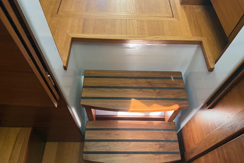 Hardy Yacht Photos Pics Wooden steps inside a 2020 Coastal Craft 33 ProFish boat, showcasing elegant craftsmanship.