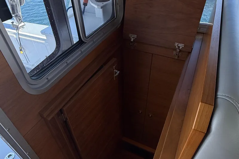 Hardy Yacht Photos Pics Interior of 2020 Coastal Craft 33 ProFish boat, featuring wooden cabinetry and window view.