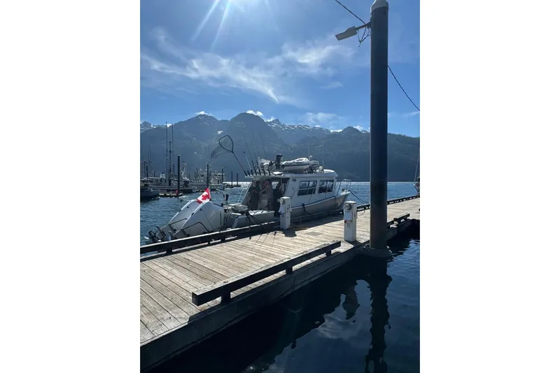 Hardy Yacht Photos Pics 2020 Coastal Craft 33 ProFish docked with scenic mountain backdrop.