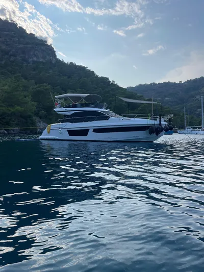  Yacht Photos Pics 2023 Azimut Fly 53 yacht on serene water with scenic mountain backdrop.