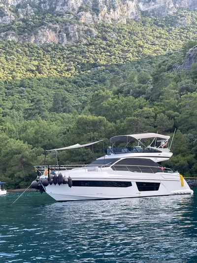  Yacht Photos Pics 2023 Azimut Fly 53 yacht anchored in scenic, forested bay.