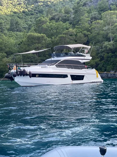  Yacht Photos Pics 2023 Azimut Fly 53 yacht anchored in scenic, forested bay.