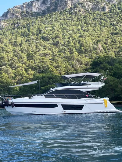 Yacht Photos Pics 2023 Azimut Fly 53 yacht on scenic water with lush green forest backdrop.