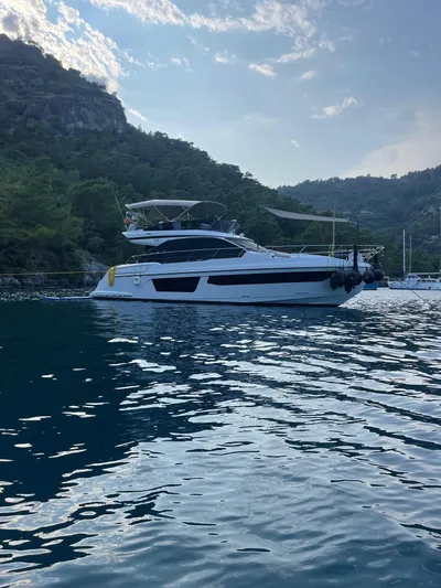  Yacht Photos Pics 2023 Azimut Fly 53 yacht anchored in scenic coastal waters.