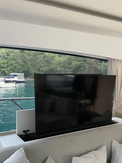  Yacht Photos Pics Luxurious interior of 2023 Azimut Fly 53 yacht with pop-up TV and scenic water view.
