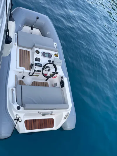  Yacht Photos Pics 2023 Azimut Fly 53 yacht's sleek deck with modern controls on calm blue water.