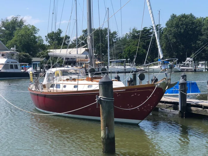  Yacht Photos Pics 1978 Hinckley Bermuda 40 MK III sailboat docked in a marina, surrounded by trees.