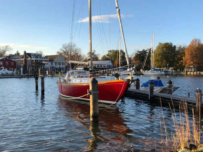  Yacht Photos Pics Red 1978 Hinckley Bermuda 40 MK III sailboat docked in a serene marina setting.