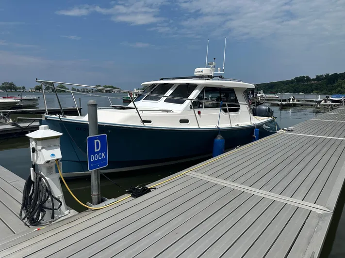  Yacht Photos Pics 2018 True North 34OE boat docked at marina under a partly cloudy sky.
