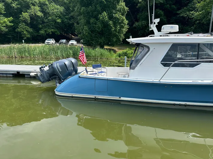  Yacht Photos Pics 2018 True North 34OE boat docked on calm water with American flag.