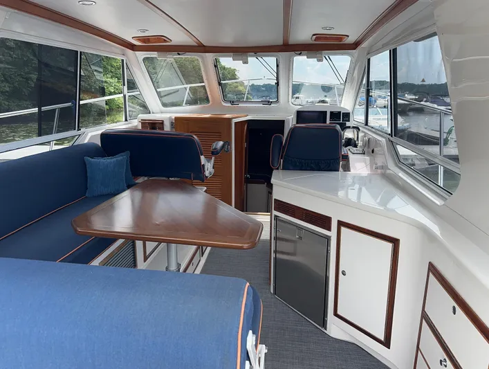  Yacht Photos Pics Interior of 2018 True North 34OE yacht with blue seating and wooden table.