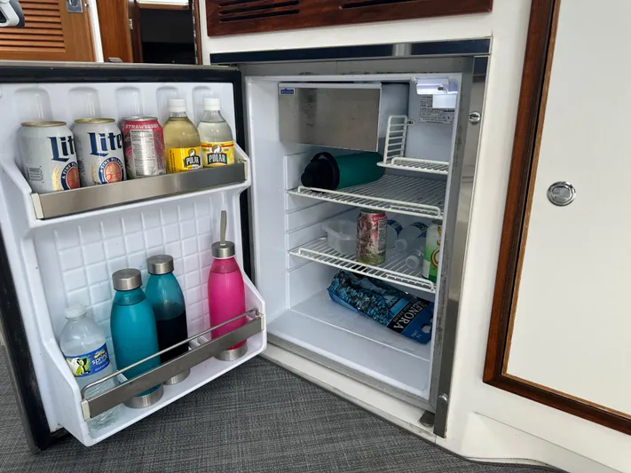 Yacht Photos Pics Open boat refrigerator with drinks and water bottles, True North 34OE, 2018 model.