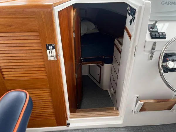  Yacht Photos Pics Cabin interior of 2018 True North 34OE boat, featuring wooden door and cozy sleeping area.