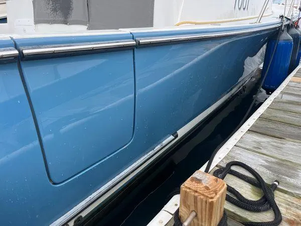  Yacht Photos Pics 2018 True North 34OE boat docked, blue hull, wooden pier, nautical ropes.
