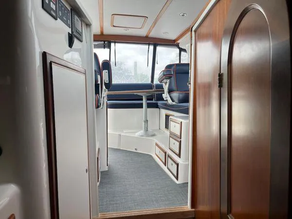  Yacht Photos Pics Interior of 2018 True North 34OE boat, featuring seating and wooden cabinetry.