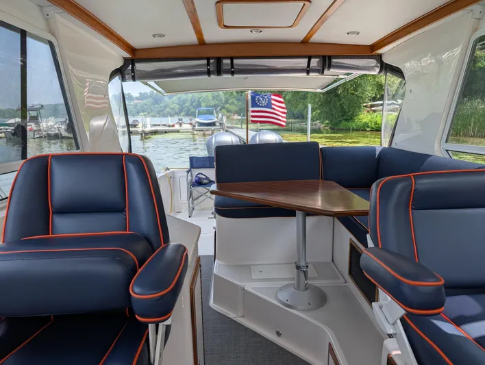  Yacht Photos Pics Interior of 2018 True North 34OE boat with blue seating and wooden table.