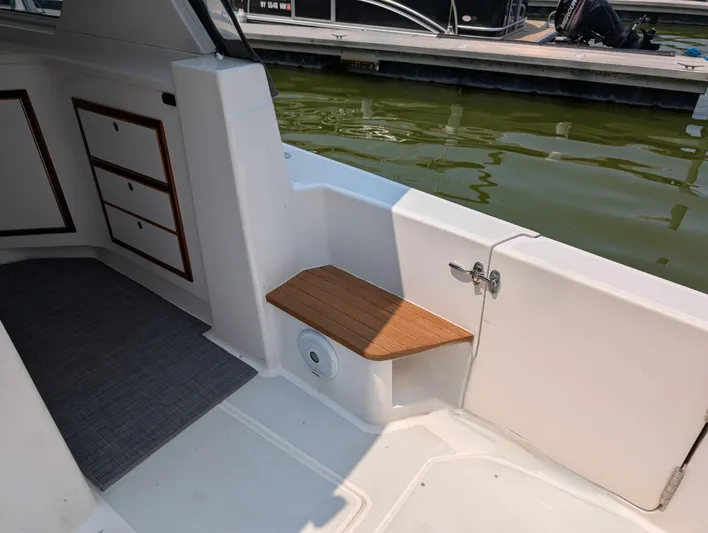  Yacht Photos Pics Interior view of 2018 True North 34OE boat with wooden seat and storage drawers.