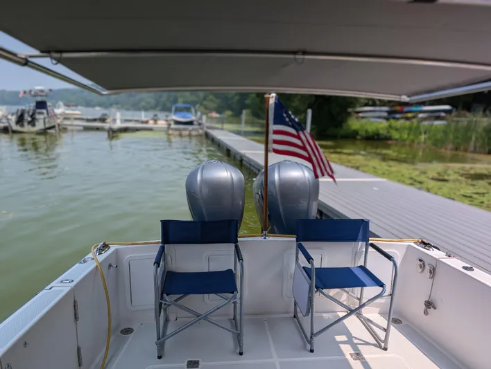  Yacht Photos Pics 2018 True North 34OE boat docked with chairs and American flag.