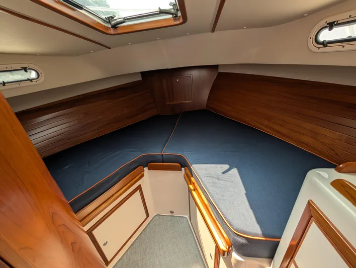  Yacht Photos Pics 2018 True North 34OE cabin interior with wood paneling and blue bedding.