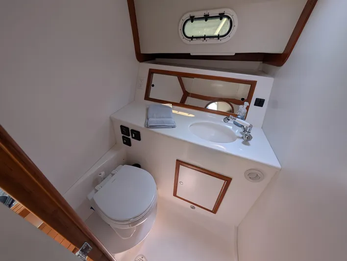  Yacht Photos Pics Compact bathroom in 2018 True North 34OE yacht with sink, toilet, and mirror.