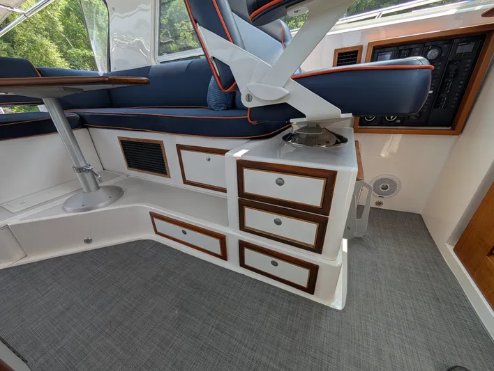  Yacht Photos Pics Interior of 2018 True North 34OE boat with seating, table, and control panel.