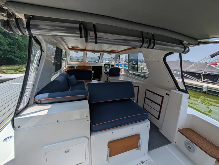  Yacht Photos Pics Interior of 2018 True North 34OE boat with blue seating and wooden accents.