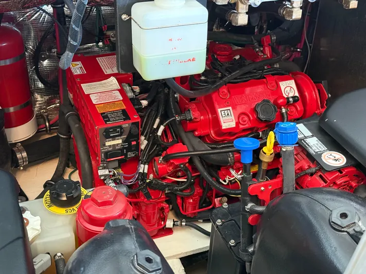 Social Distance Yacht Photos Pics Engine compartment of a 2019 Regal 35 Sport Coupe, featuring red components and various fluid reservoirs.
