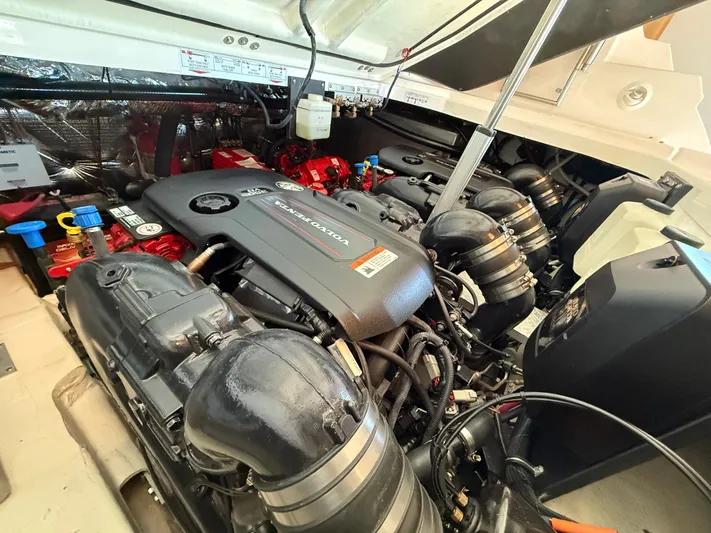Social Distance Yacht Photos Pics Engine compartment of a 2019 Regal 35 Sport Coupe, showcasing powerful machinery.