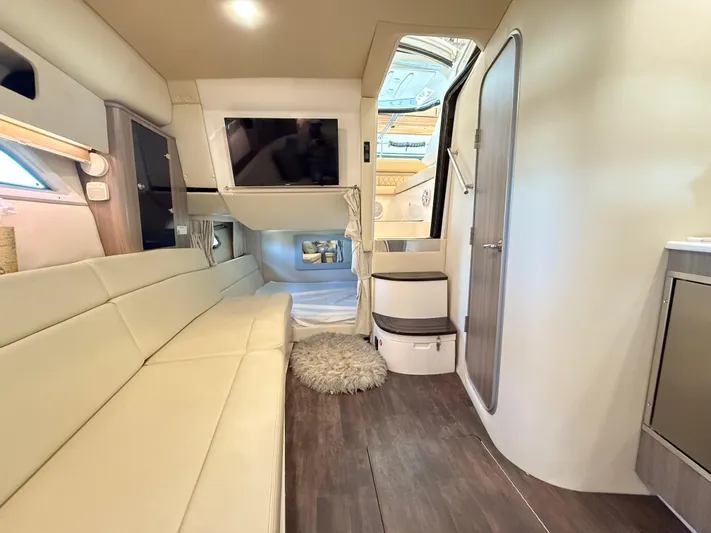 Social Distance Yacht Photos Pics Interior of 2019 Regal 35 Sport Coupe with modern seating, TV, and cozy sleeping area.
