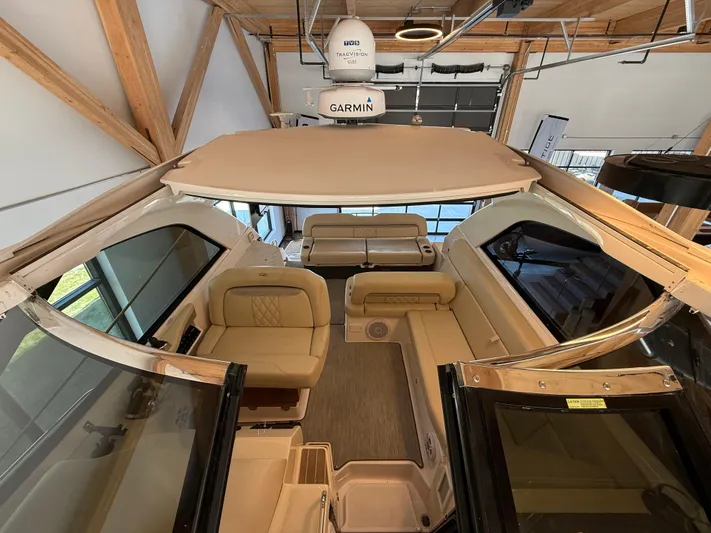 Social Distance Yacht Photos Pics 2019 Regal 35 Sport Coupe interior with beige seating and Garmin equipment.