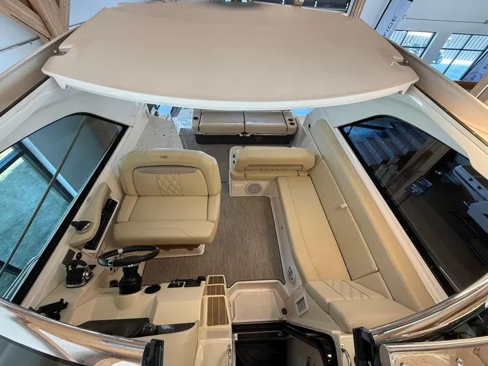 Social Distance Yacht Photos Pics 2019 Regal 35 Sport Coupe interior with beige seating and modern helm.