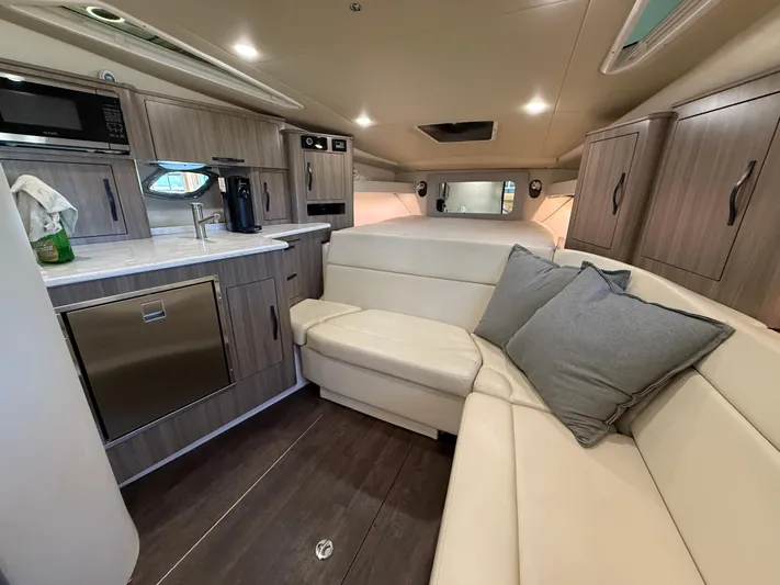 Social Distance Yacht Photos Pics 2019 Regal 35 Sport Coupe interior with modern kitchen and cozy seating area.