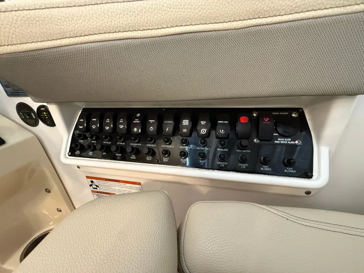 Social Distance Yacht Photos Pics Control panel of a 2019 Regal 35 Sport Coupe boat with various switches.
