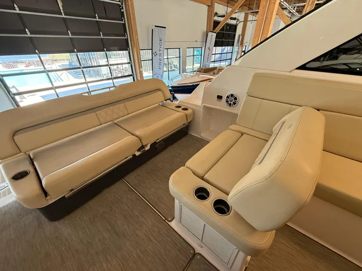 Social Distance Yacht Photos Pics 2019 Regal 35 Sport Coupe interior with beige seating and cup holders.