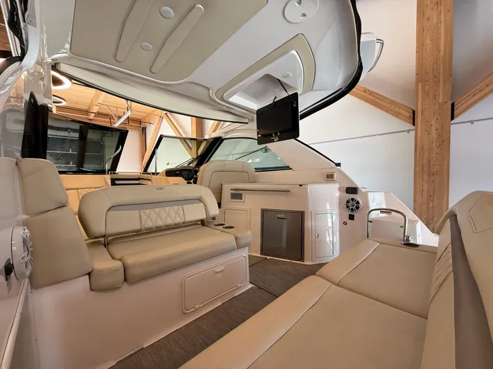 Social Distance Yacht Photos Pics 2019 Regal 35 Sport Coupe interior with beige seating, modern amenities, and sleek design.