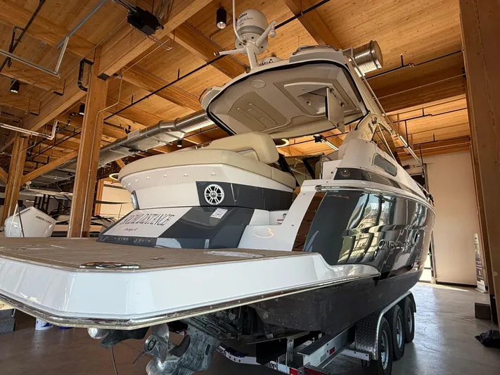 Social Distance Yacht Photos Pics 2019 Regal 35 Sport Coupe boat in a wooden indoor storage facility.