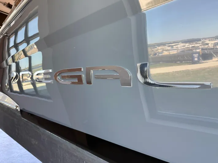 Social Distance Yacht Photos Pics 2019 Regal 35 Sport Coupe logo on sleek gray surface.