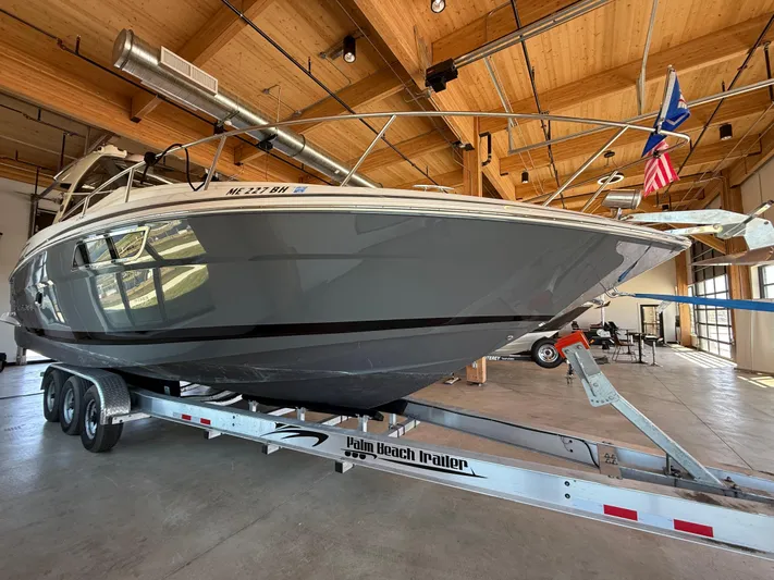 Social Distance Yacht Photos Pics 2019 Regal 35 Sport Coupe boat on trailer in wooden-ceiling garage.