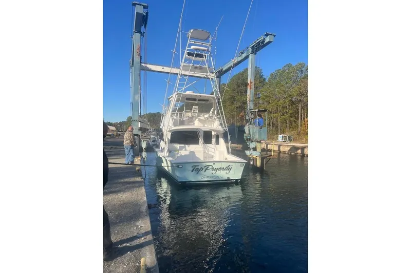 Our Trade II Yacht Photos Pics 1996 Ocean Yachts 48 Super Sport in a boat lift at a marina.