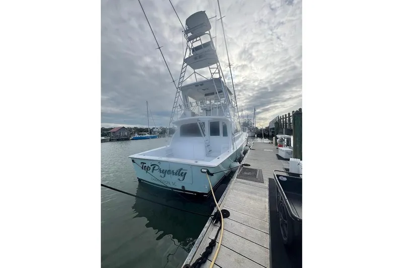 Our Trade II Yacht Photos Pics 1996 Ocean Yachts 48 Super Sport docked, overcast sky, marina setting.